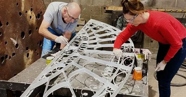 Marie Palmer the Cast Iron Welding Services Director gets involved with the painting of a historic window welding restoration