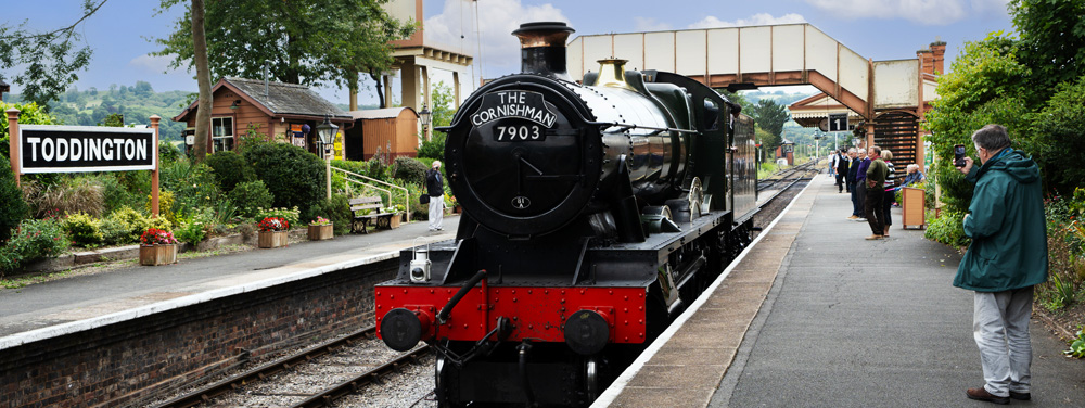 here is an image showing a restored steam train at Toddington station on the Gloucester and Warwickshire railway